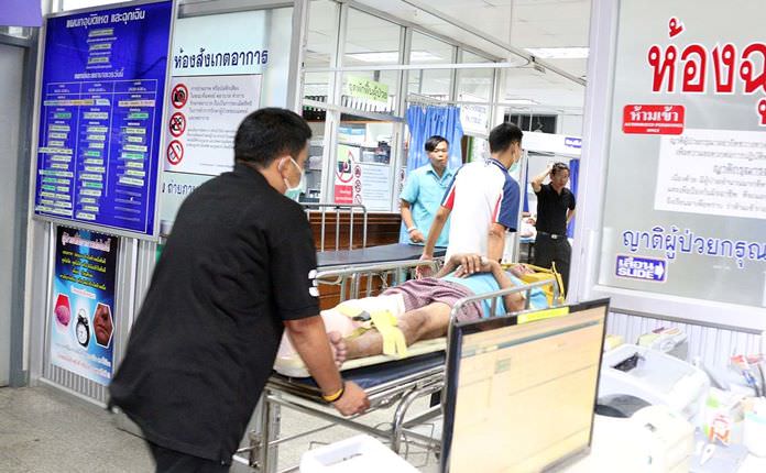 Nukul Bamrungwat is wheeled into the emergency room after being shot in the leg.