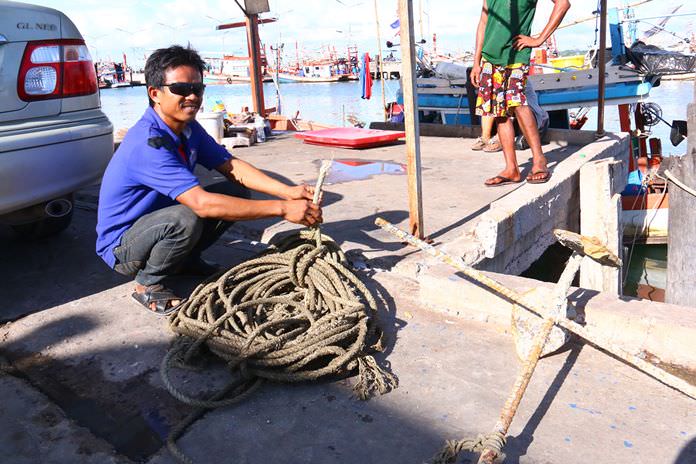 Somai Namwong shows the rope his boat had been tied to before it disappeared to the bottom of Pattaya Bay.