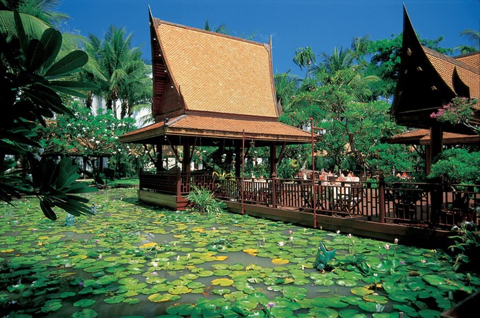 Sala Rim Nam is encircled by lotus ponds and tropical flora.