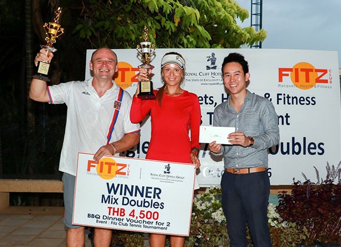 Vitanart Vathanakul (right), Executive Director of the Royal Cliff Hotels Group, presents trophies and prizes to Daniel Rajsky (left) and Anastasia Pimenova, the winners of the Mixed Doubles title at the 8th Fitz Club Tennis Tournament.