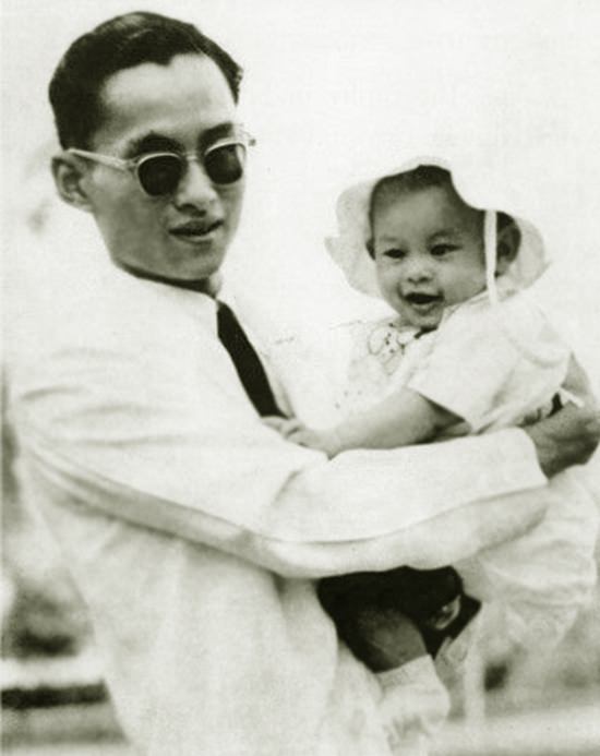 Photo of King Rama IX carrying HM King Maha Vajiralongkorn Bodindradebayavarangkun while he was a child.