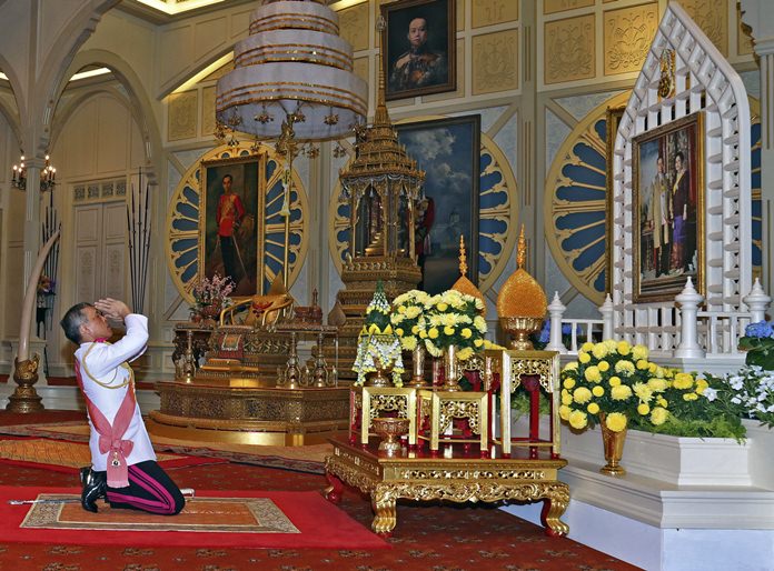 HM King Maha Vajiralongkorn Bodindradebayavarangkun pays his respects to a portrait of HM the late King Bhumibol Adulyadej and HM Queen Sirikit at the Dusit Palace Thursday, Dec.1, 2016. (Bureau of the Royal Household via AP)