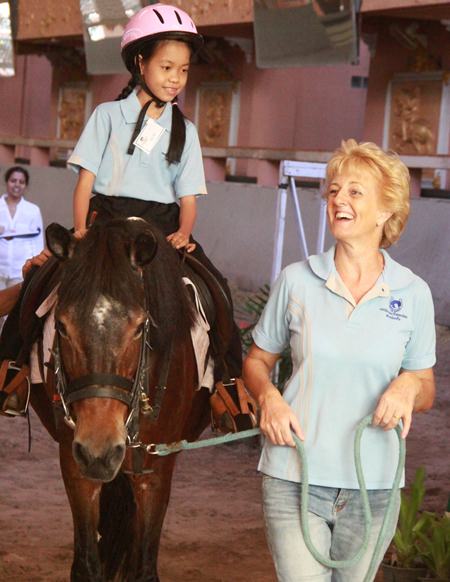 Calmly trotting around the arena.