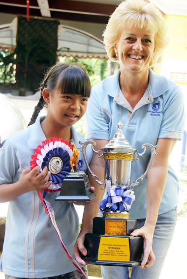 The dressage winner receives her trophies from Sandra Cooper.