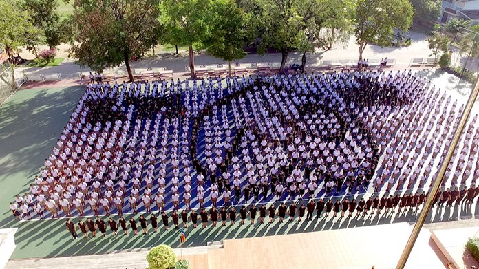 1,300 students and 75 teachers from Plutaluang Wittaya School line up in formation in a giant Thai numeral 9 to pay tribute to HM the late King.