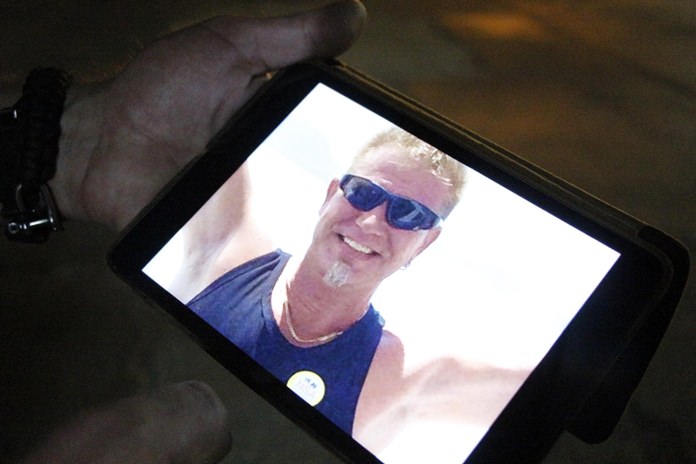 Vuori Emil Juhani shows a photo of himself wearing the gold necklace stolen from him in a ride by theft.