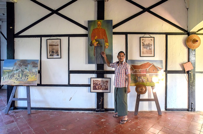 Amateur George Orwell scholar Nyo Ko Naing points to a portrait of a former British colonial official inside a planned museum to be dedicated to the famous British author in Katha, Myanmar. (AP Photo/Aung Naing Soe)