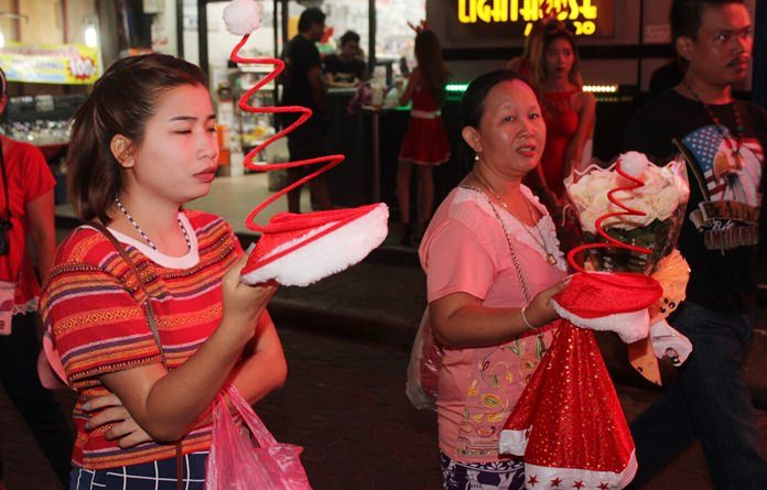 Vendors were doing brisk business selling Santa gear on Walking Street.