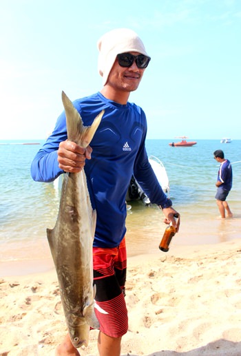 A participant takes his catch to the judging officials to have it weighed.