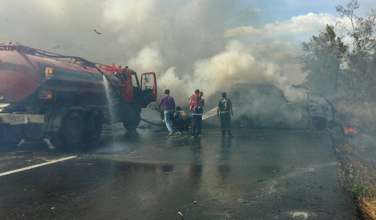 Rescue workers try desperately to save victims from the crash inferno that resulted in the death of 25 Thai passengers and drivers.