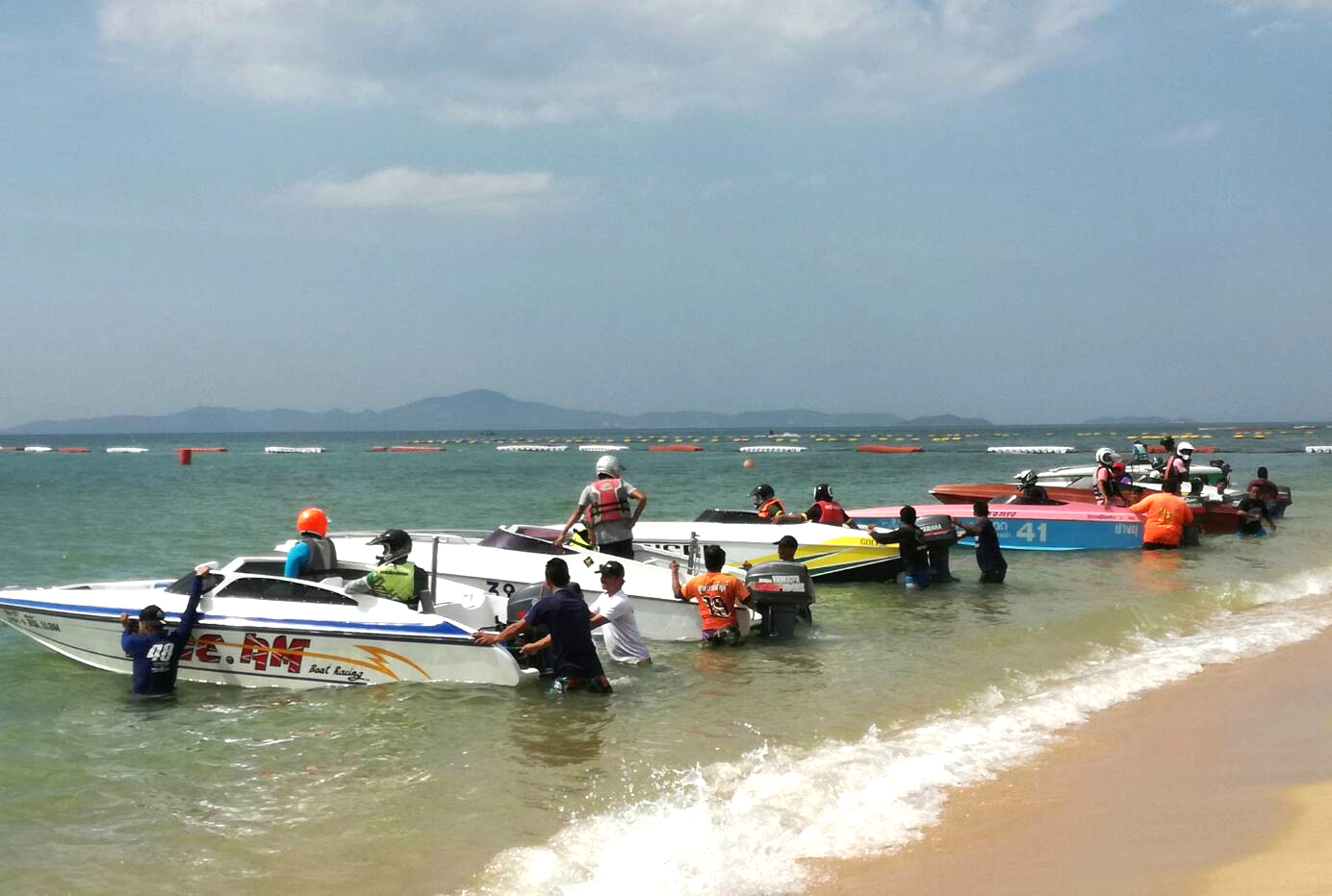Boats line up on Jomtien beach at the start of another race.