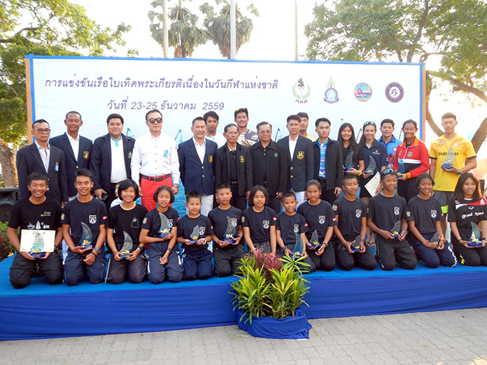 Trophy winners pose on the podium with regatta organizer and Thai Navy officials.