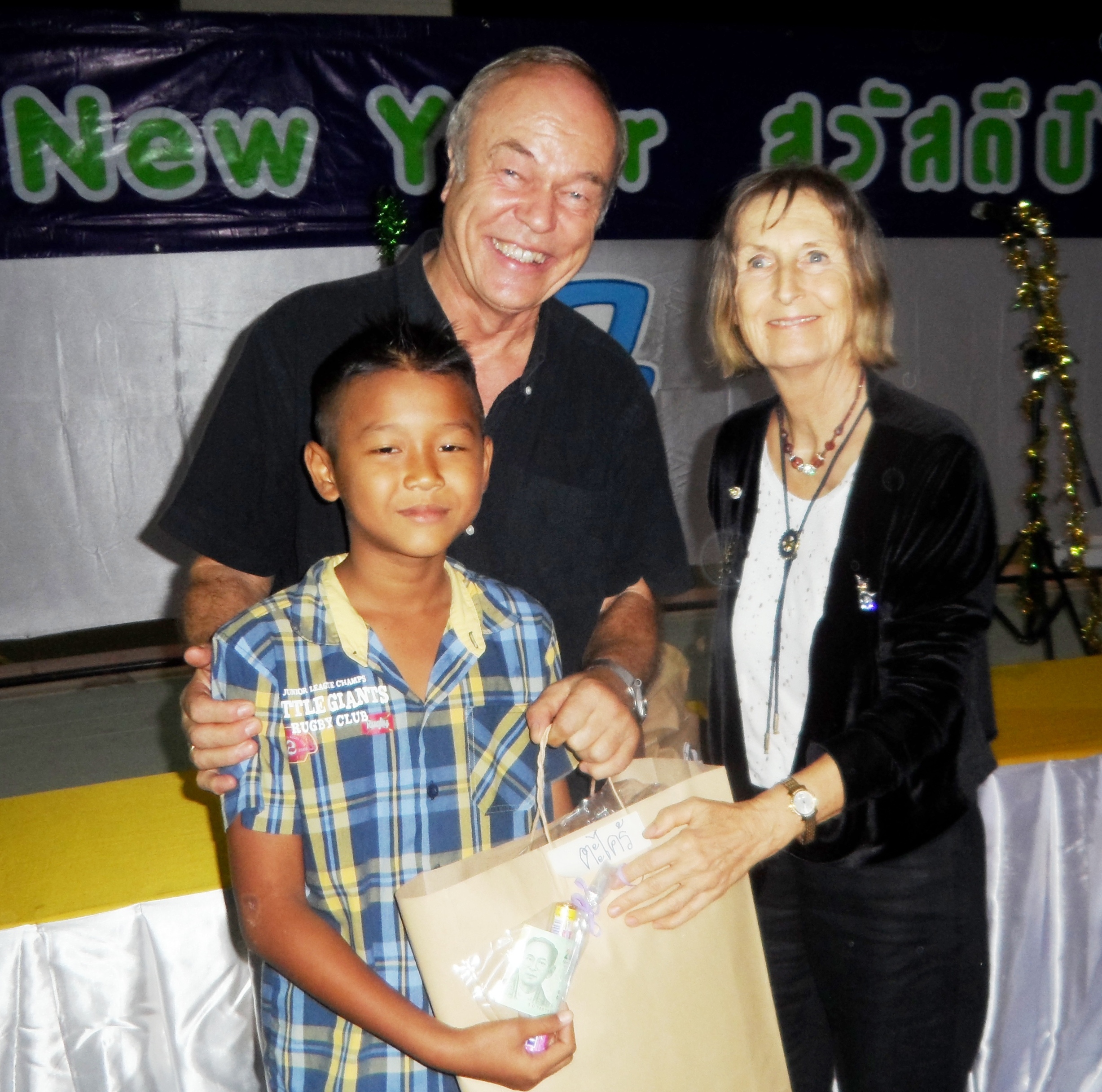 Pastor Liebe and Dr. Margret Deter give presents to the kids.