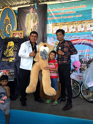 One lucky guy won a teddy bear that was bigger than he was.