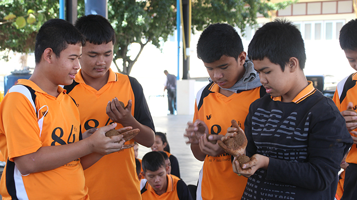 Nong Ket Yai students are shown how to make 2,500 effective-microorganism balls to consume the sewage polluting the lake.