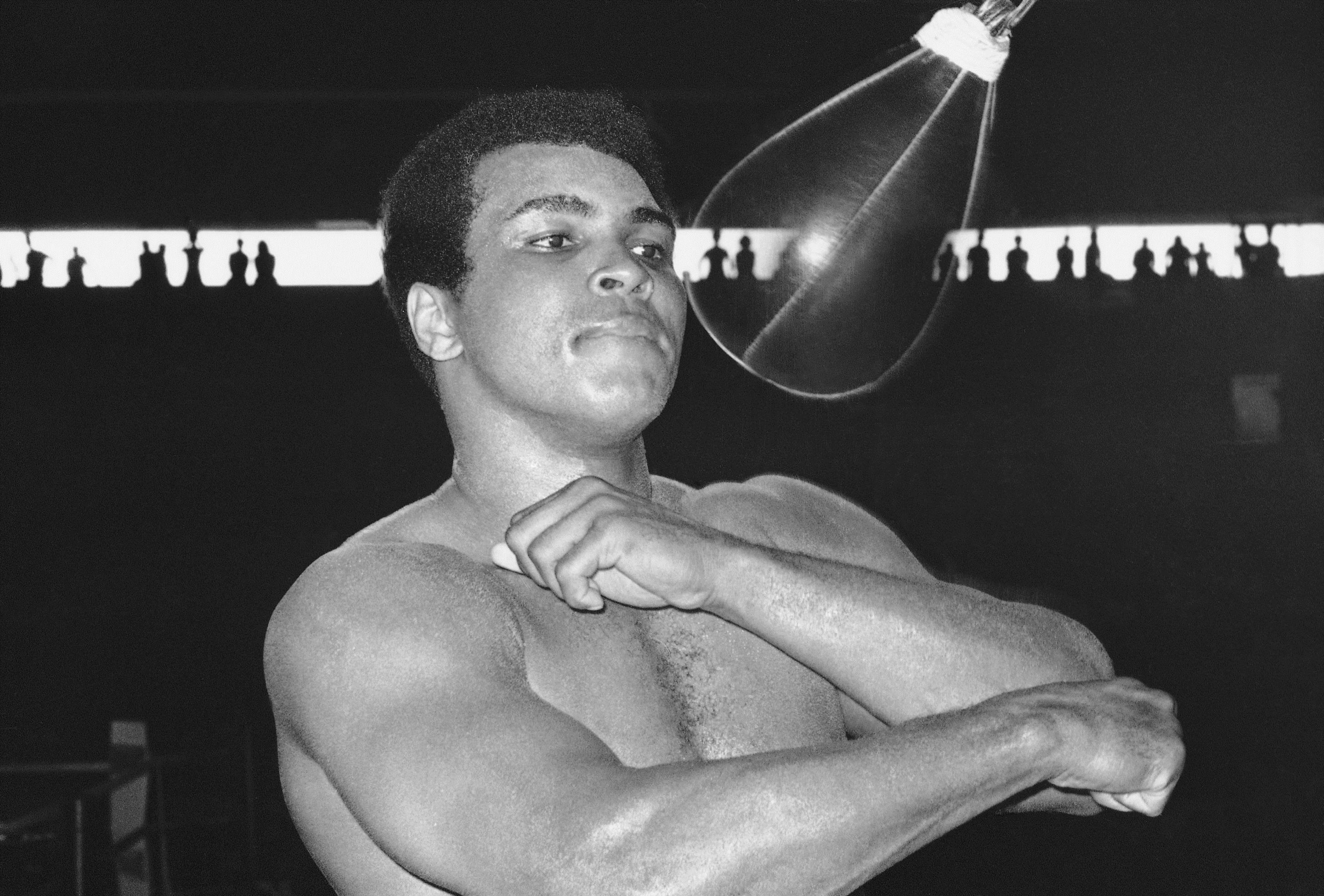 Muhammad Ali punches a speed bag at the Folk Art Center in Manila, Philippines in this Sept. 29, 1975, file photo. When Ali wasn't jabbing or dancing in the ring, he sometimes dabbled as an artist. (AP Photo/Jess Tan)