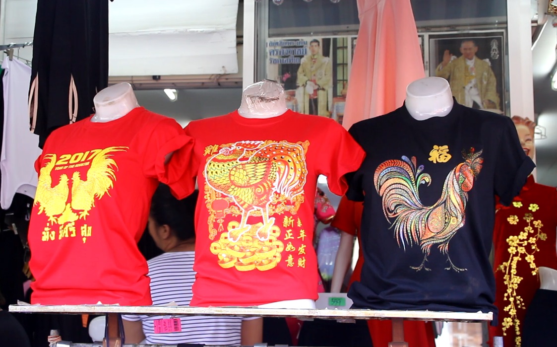 With most Thais still wearing black, brilliant red and gold qipao dresses didn’t sell well for Chinese New Year.