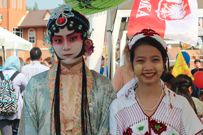 An Ancient Chinese Opera performer greets a young lass from Myanmar.