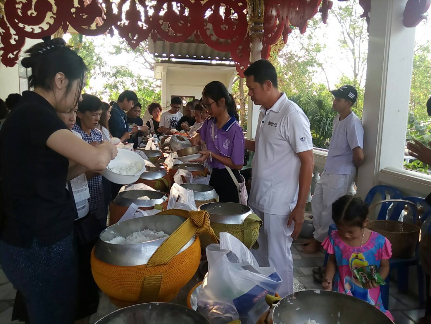 People offer foods to monks in the morning.