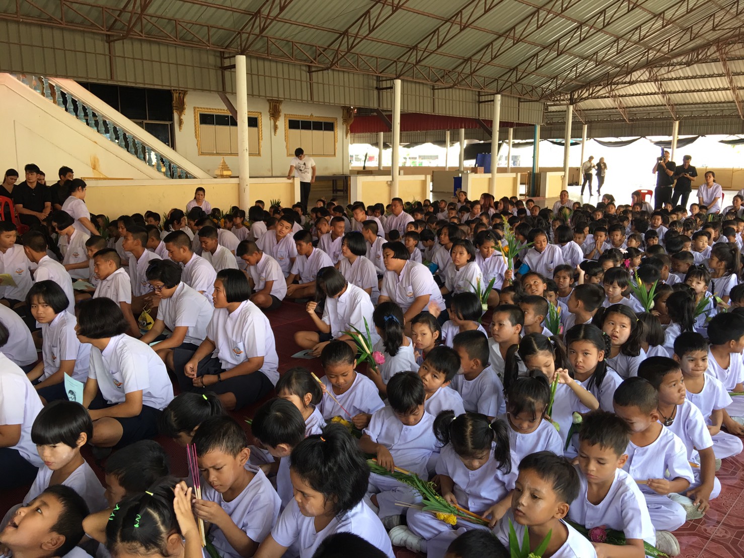 Children at the Wat Sutthawat Child Development Center paid respects to the images of Buddha and listened to the sermon by Abbot Wichai Thitanamo.