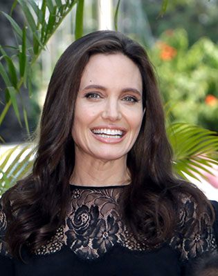 Hollywood actress Angelina Jolie smiles before a press conference in Siem Reap province, Cambodia, Saturday, Feb. 18. (AP Photo/Heng Sinith)