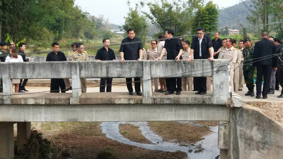 Deputy Prime Minister General Thanasak Patimaprakorn checks out the repair and reconstruction of the Huay Sua Bridge after it was severely damaged in flash floods last year.