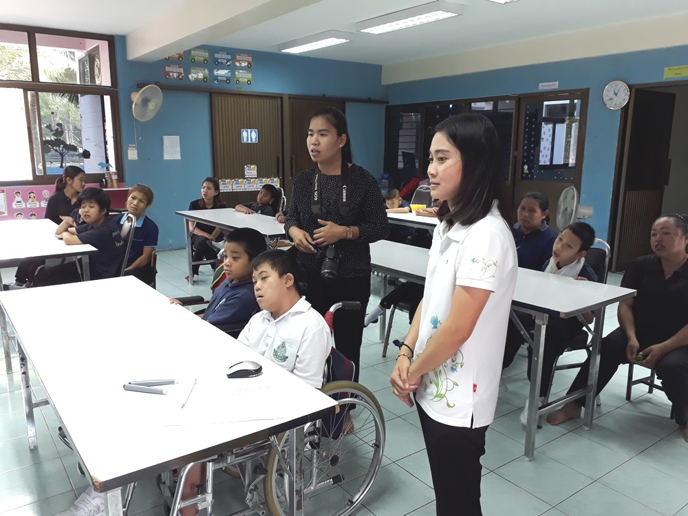 The rest of the class look on intently.