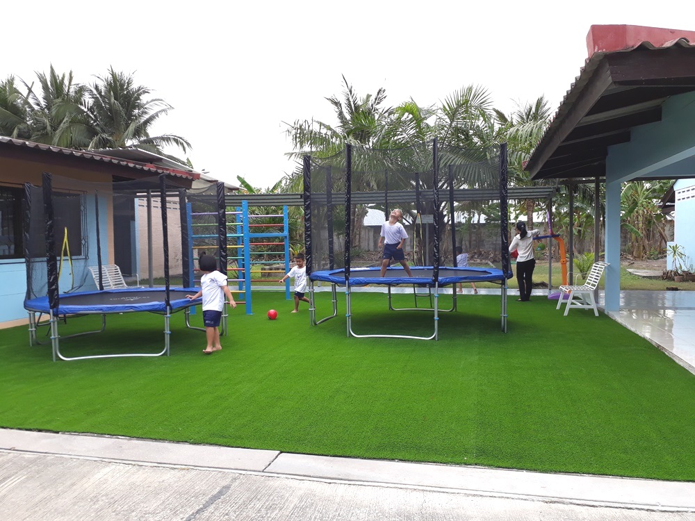 The autistic children enjoy the trampoline.