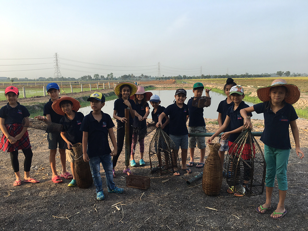 The kids show off their bumper catch of frogs and fish.