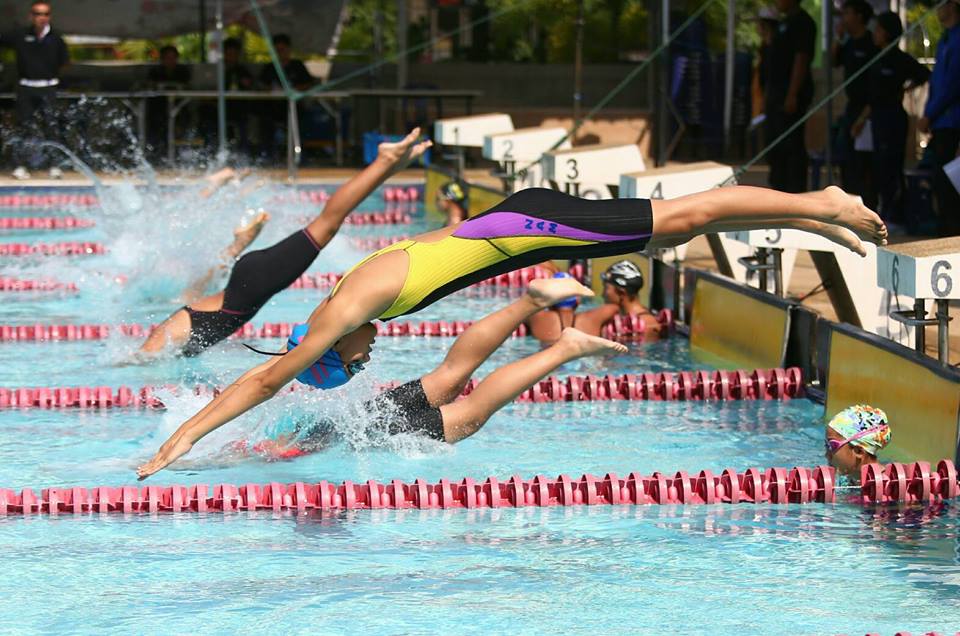 Competitors hit the pool during a team relay race at the 14th annual Pattaya Swimming Open championships at City School 11 on March 12.