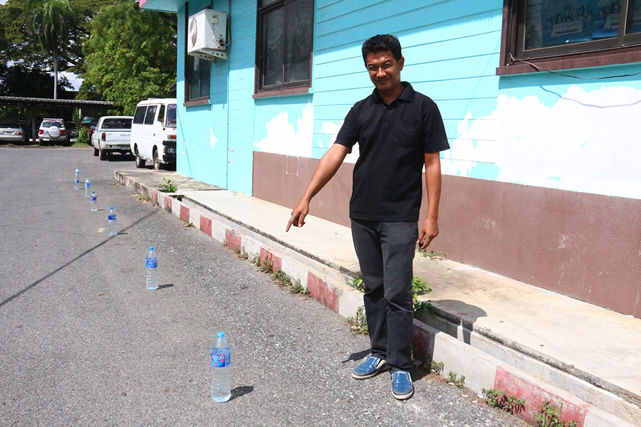 VDC Volunteer Jaran Kongbandit points to the office’s new solution to illegal parking.