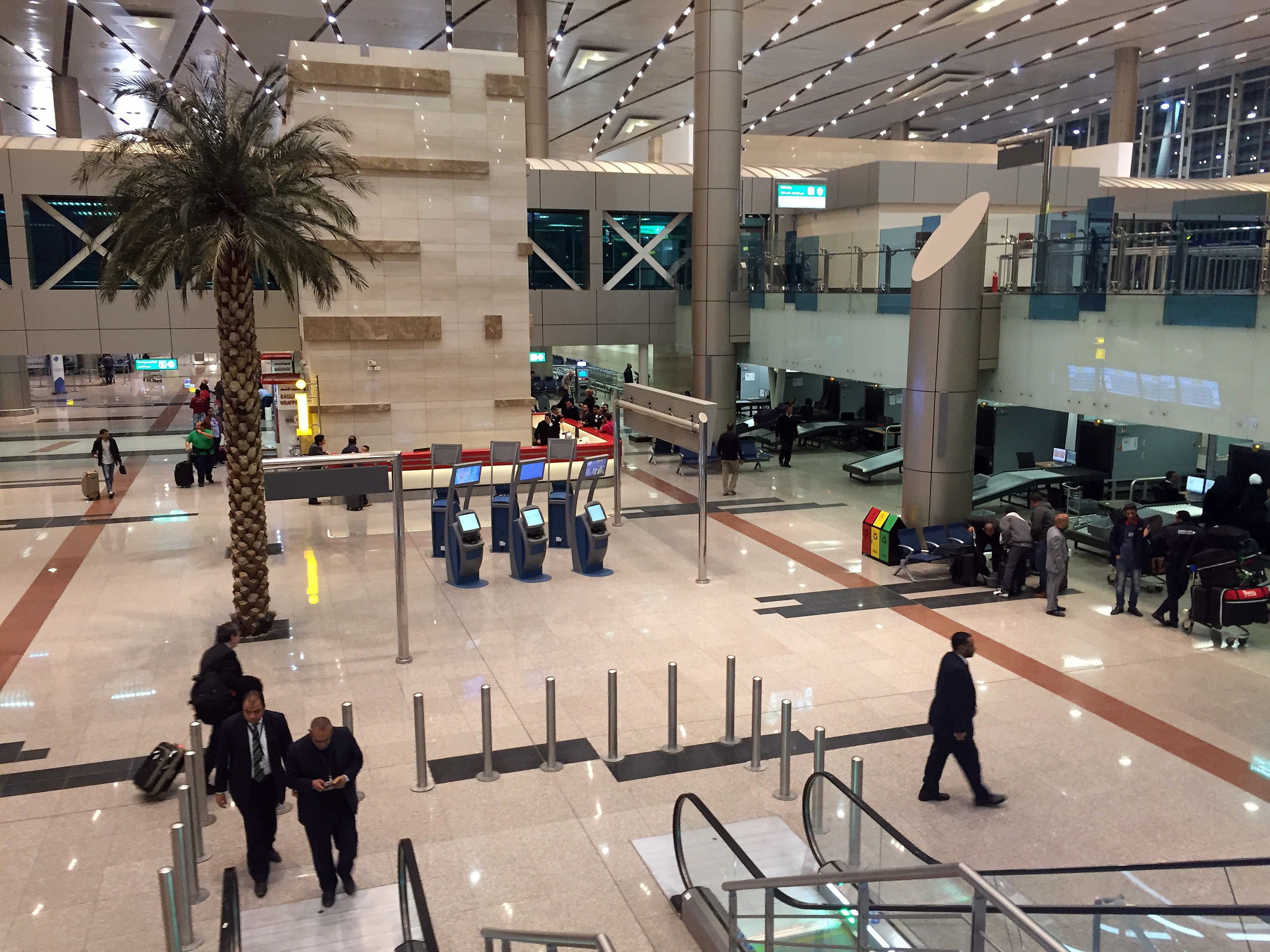 Airport staff gather near a security checkpoint at Cairo International Airport on Tuesday, March 21, 2017. The U.S. and British governments, citing unspecified threats, are barring passengers on some international flights from mostly Middle Eastern and North African countries from bringing laptops, tablets, electronic games and other devices on board in carry-on bags. (AP Photo)