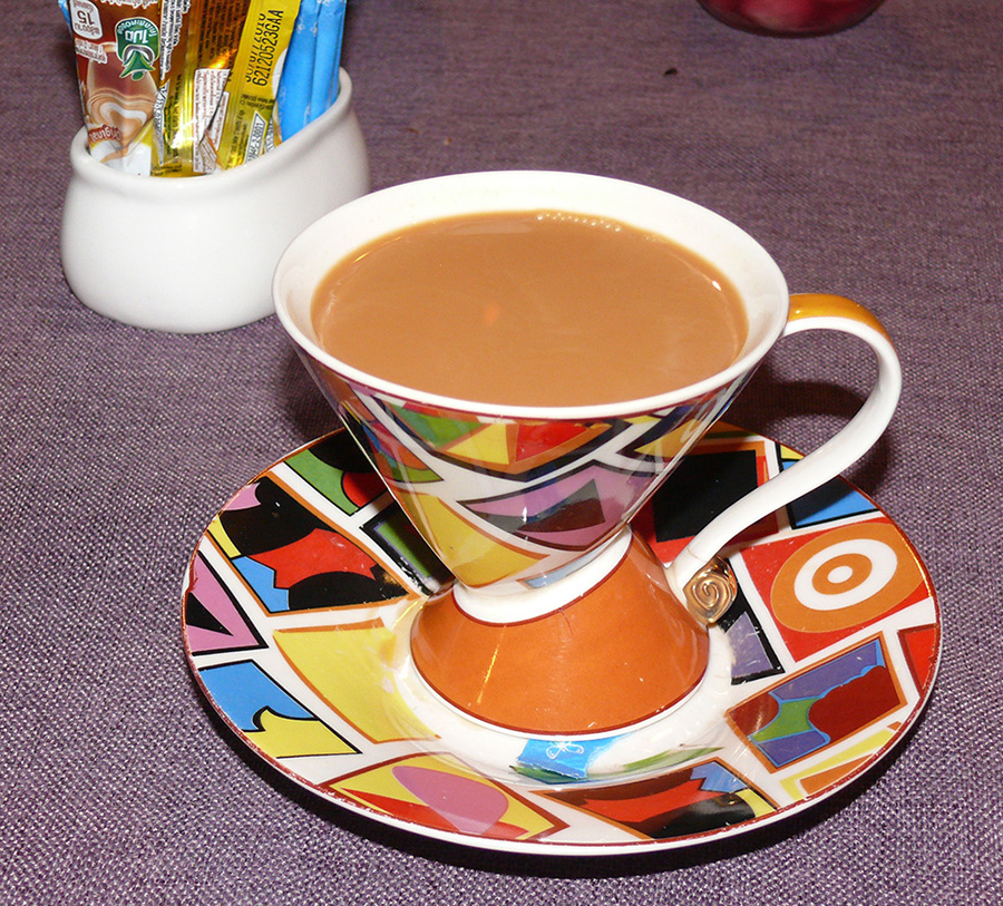 The exotic Masala Chai brewed with a mixture of aromatic Indian spices and herbs, served in a Clarice Cliff cup and saucer.