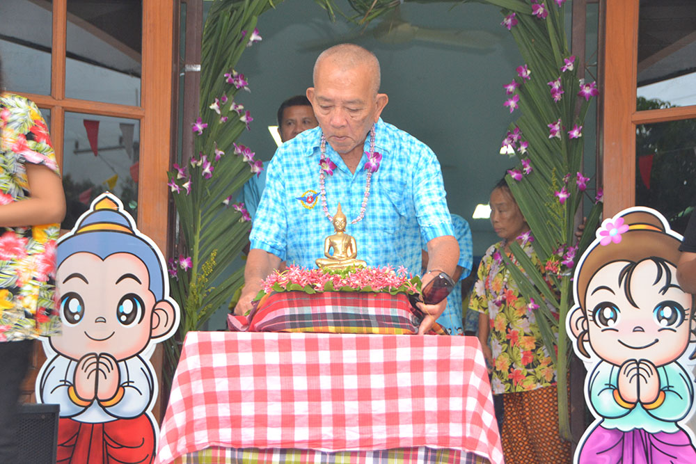 The Buddha image is placed in its revered spot in time to begin the bathing ritual.