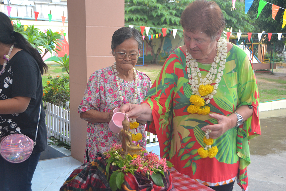 Benefactors pour fragrant water on the Buddha statue as part of the bathing the Buddha image for Songkran at the Fountain of Life Pattaya.