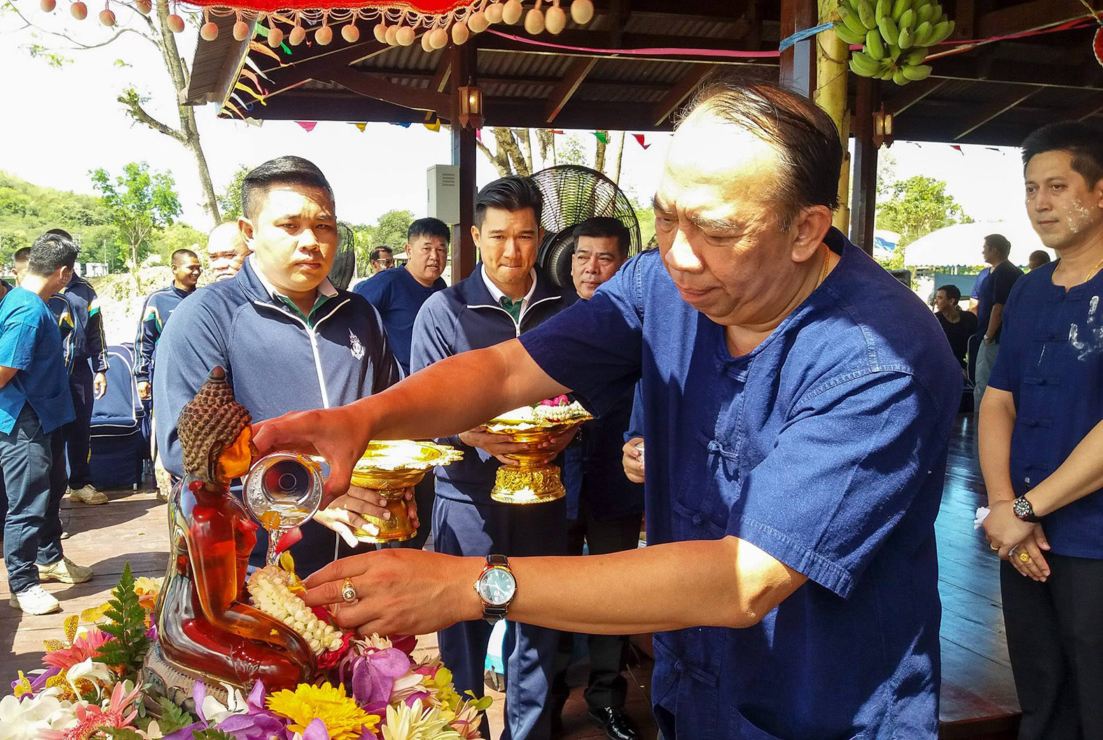 Rear Adm. Eakaraj Phomlumpak, commander of the Air and Coastal Defense Command, pours scented water on the Buddha statue.