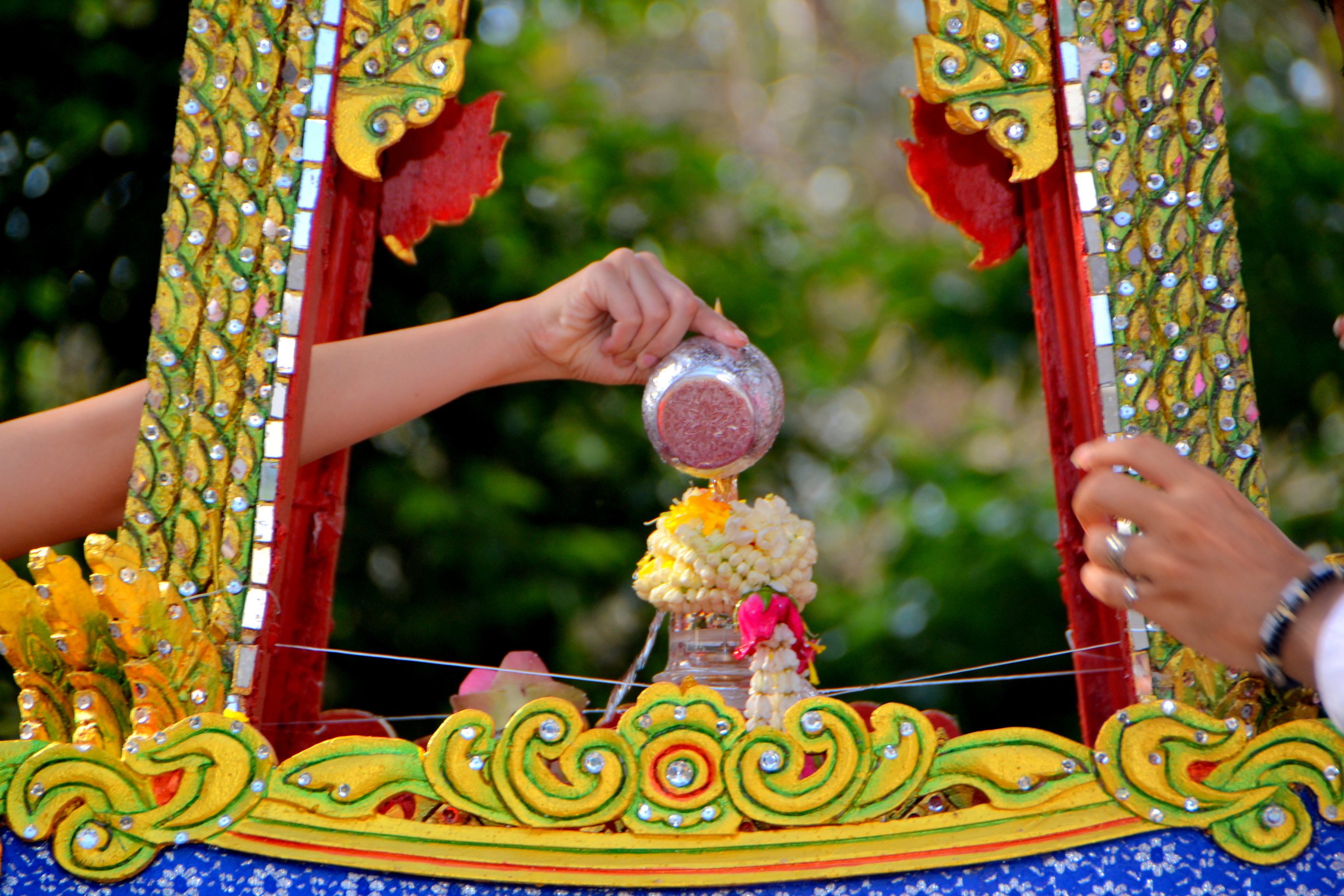 The parade gives residents and tourists an opportunity to pour holy water the relics on Songkran Day.