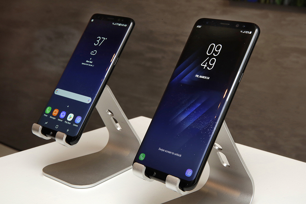 In this Friday, March 24, 2017, photo, new Samsung Galaxy S8, left, and Galaxy S8 Plus mobile phones are displayed in New York. The Galaxy S8 features a larger display than its predecessor, the Galaxy S7, and sports a voice assistant intended to rival Siri and Google Assistant. (AP Photo/Richard Drew)
