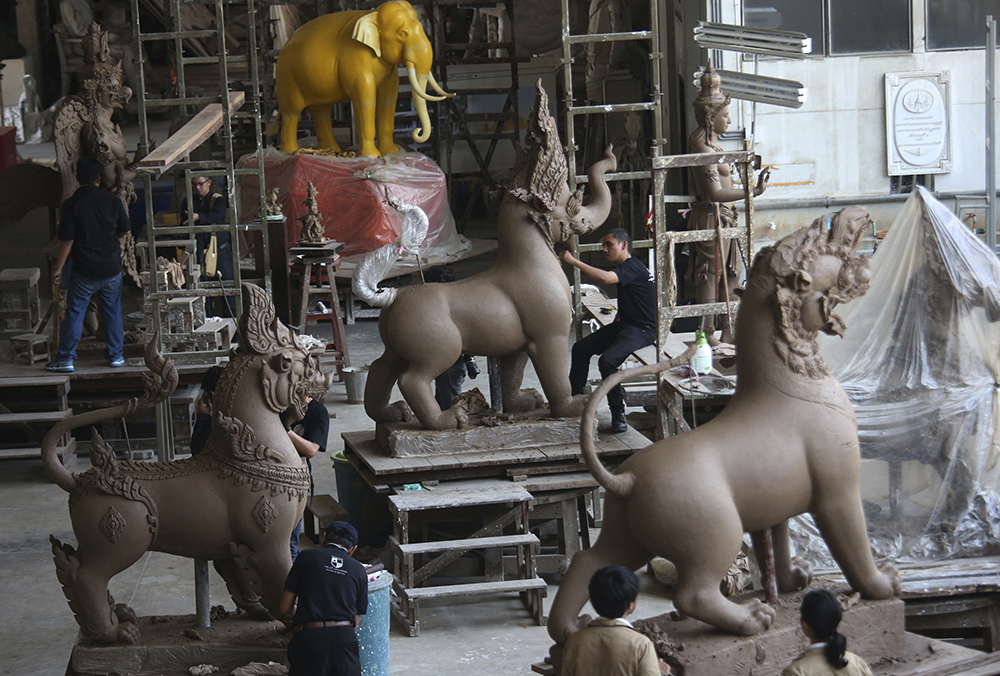 Artisans working on sculptures of deities and creatures from ancient Indian epics to decorate the royal crematorium for the late King Bhumibol Adulyadej at the Office of Traditional Arts in Nakhon Pathom province. (AP Photo/Sakchai Lalit)