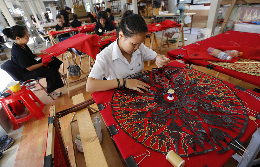 Women embroider intricate patterns to decorate the royal crematorium for the late Thai King Bhumibol Adulyadej at the Office of Traditional Arts in Nakhon Pathom province, Thursday, April 20, 2017. (AP Photo/Sakchai Lalit)