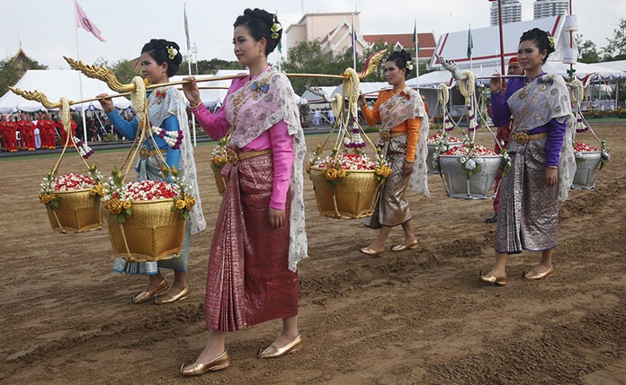 Royal attendants carry sacred seed rice during royal ploughing ceremony. The annual event marks the beginning of the growing season in Thailand for rice. (AP Photo/Sakchai Lalit)
