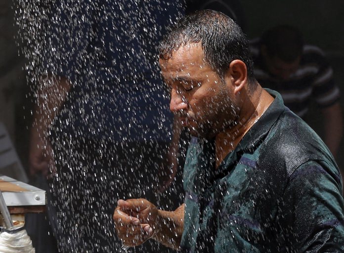 Most people on Earth have already felt extreme and record heat, drought or downpours goosed by man-made global warming, a new study finds. (AP Photo/Karim Kadim, File)