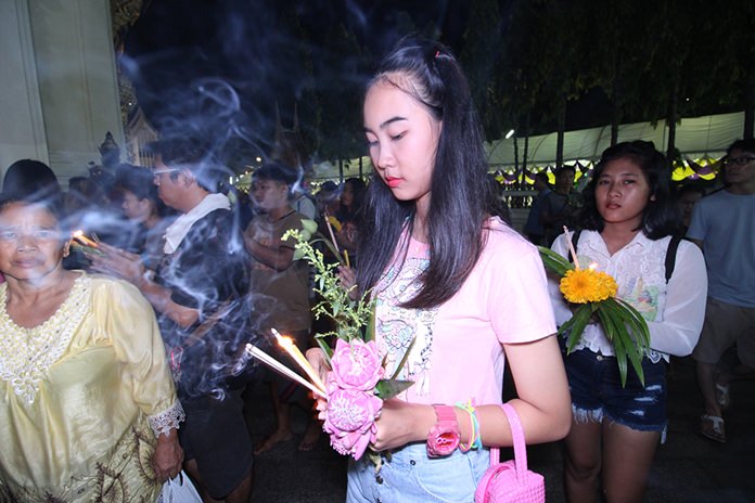 Young and old finish their day with the traditional meditative procession clockwise three times around the temple.