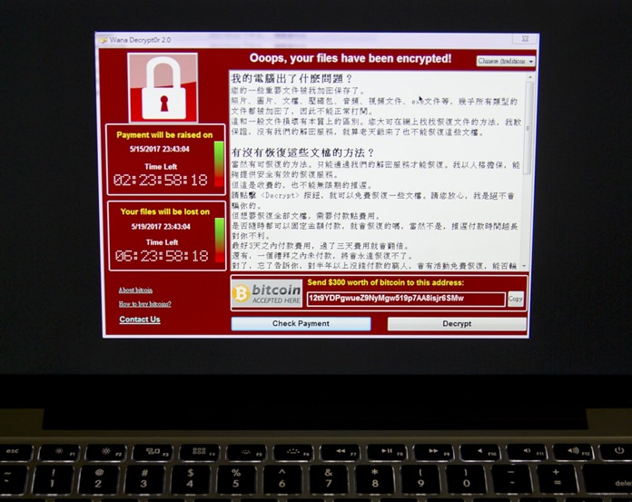 A screenshot of the warning screen from a purported ransomware attack, as captured by a computer user in Taiwan, is seen on laptop in Beijing, Saturday, May 13, 2017. Dozens of countries were hit with a huge cyberextortion attack Friday that locked up computers and held users’ files for ransom at a multitude of hospitals, companies and government agencies. (AP Photo/Mark Schiefelbein)