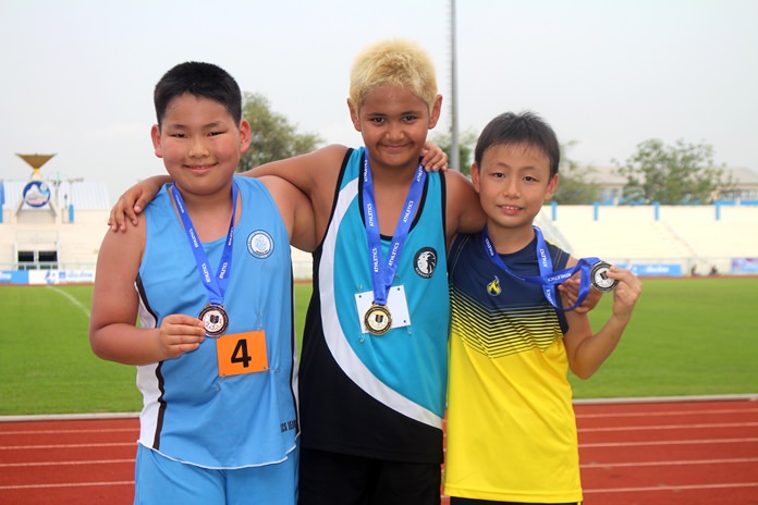A trio of aspiring athletes pose for a photo during the track and field section of the Games. 