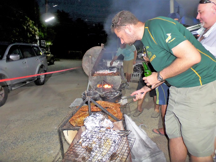 Bernie Lamprecht keeps one eye on the BBQ and the other on his beer.