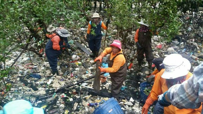 Workers clean the Nok Yang Canal and a nearby mangrove forest, while officials announced those caught dumping garbage there will be prosecuted for environmental crimes.