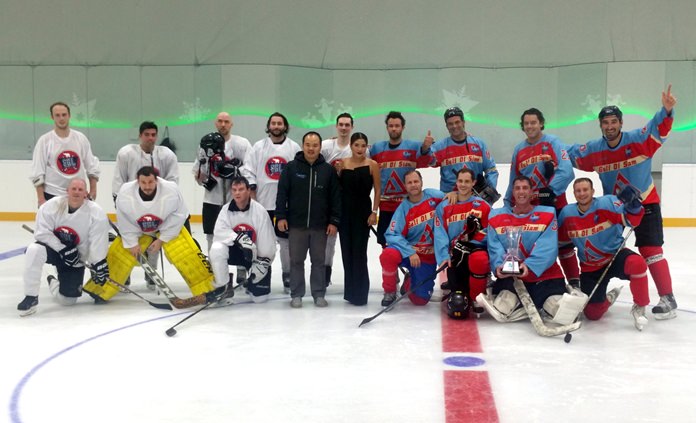 Jogsports Sweaters (right) pose with the trophy after defeating SHL Selects (left) in the Gulf of Siam ice hockey tournament final at the Harbor Mall in Pattaya, Saturday, May 20.