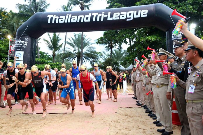 Male athletes set off at the start of the Toyota Pattaya Triathlon on Pattaya Beach.