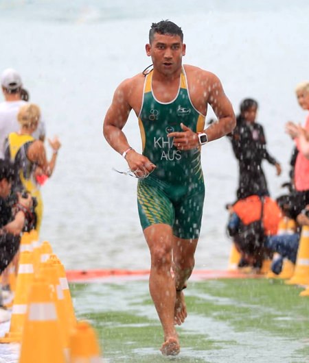 A triathlon competitor exits the water after the 1.5km swim